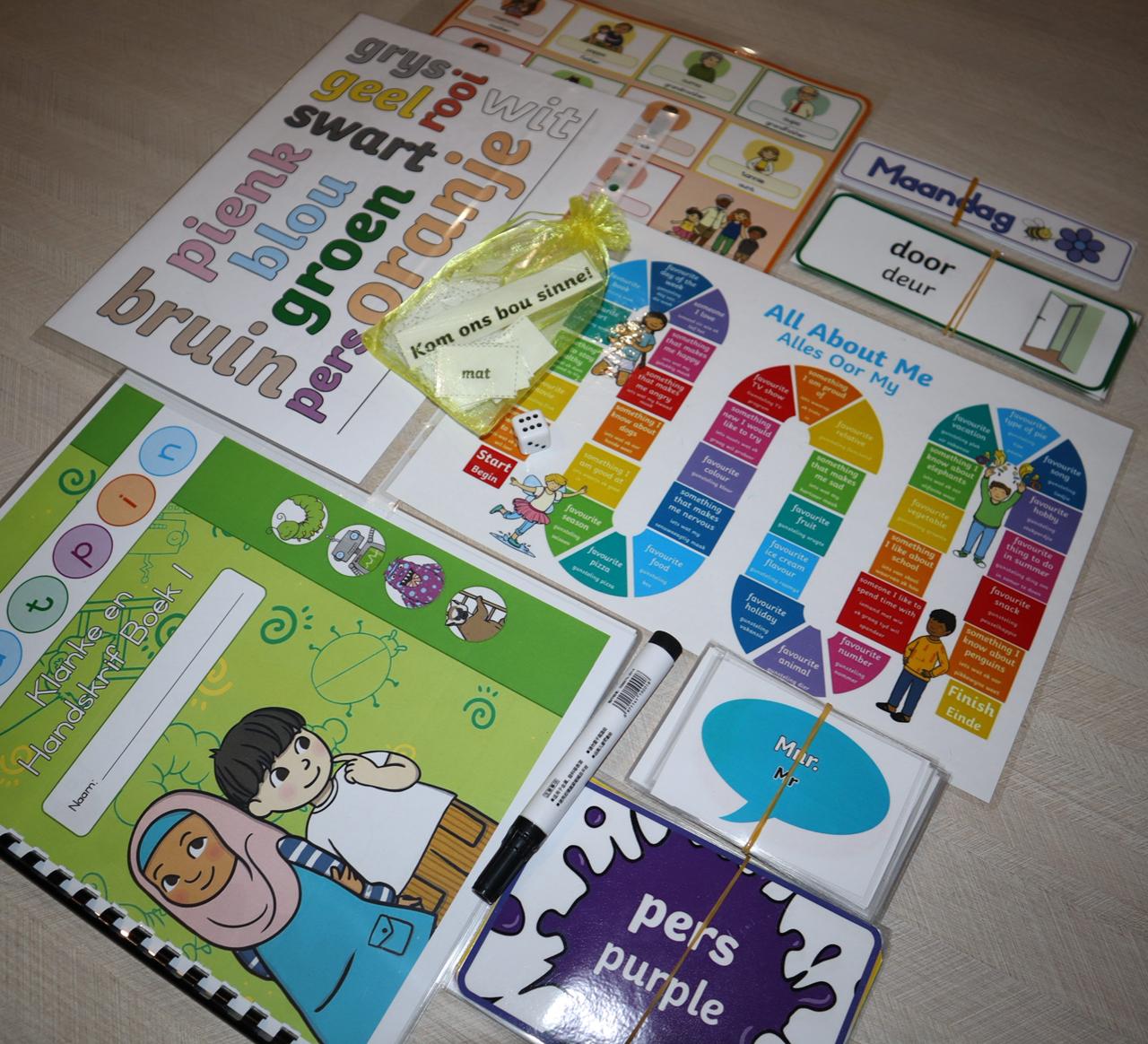 Afrikaans Educational Box contents including workbook, flash cards, board game, and colouring activities