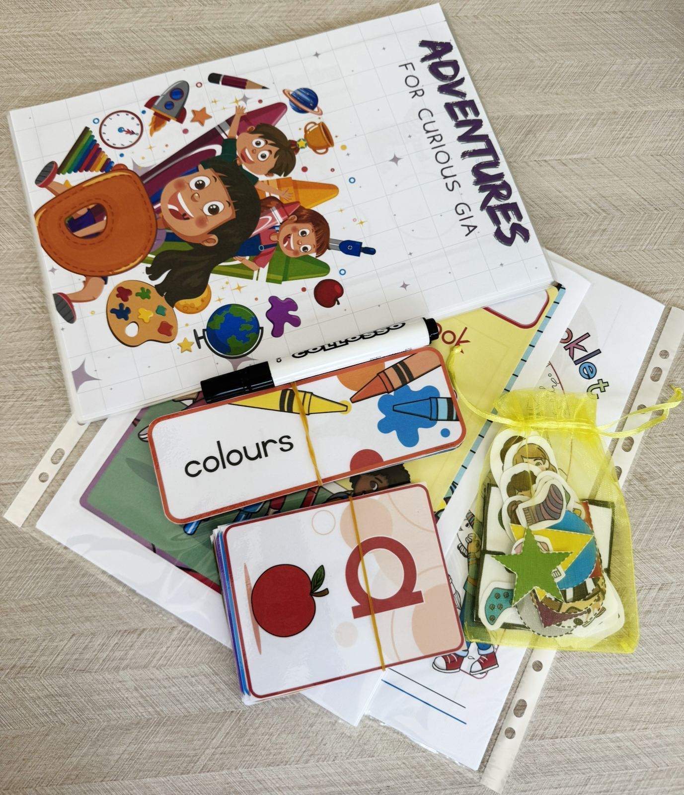 Toddler Box contents including activity books, color cards, illustrated pages, and learning materials